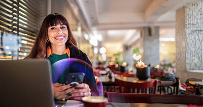 femme-assise-devant-un-ordinateur-portable-avec-son-café